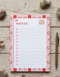 Notepad with cute design on a wooden surface
