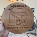 Round wooden welcome sign engraved with the word "Welcome" hanging on a front door