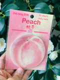 Peach sticky notes stuck on a planner page next to a pen