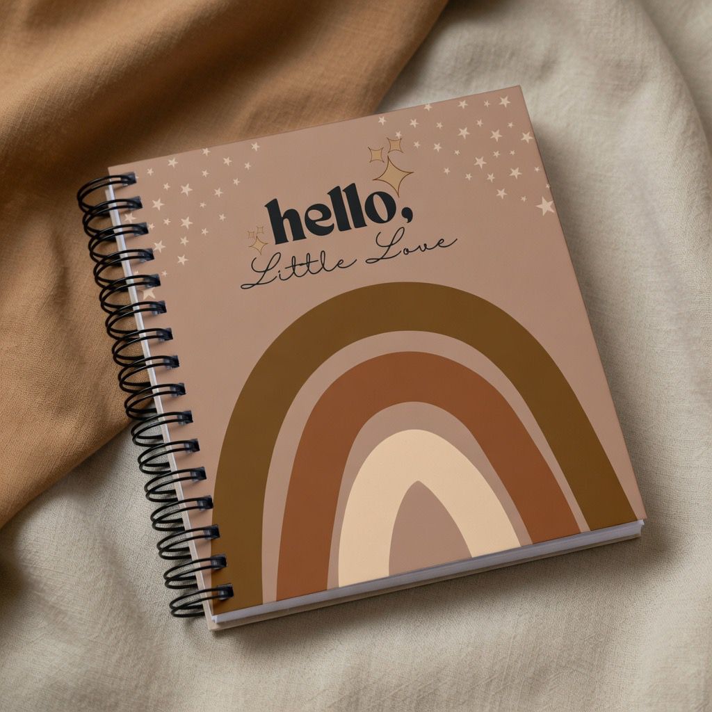 Levara baby book with brown rainbow design and hello little love text on spiral bound cover