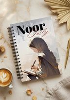 Levara Noor Daily 3 month planner featuring an artistic cover with a woman writing in a notebook
